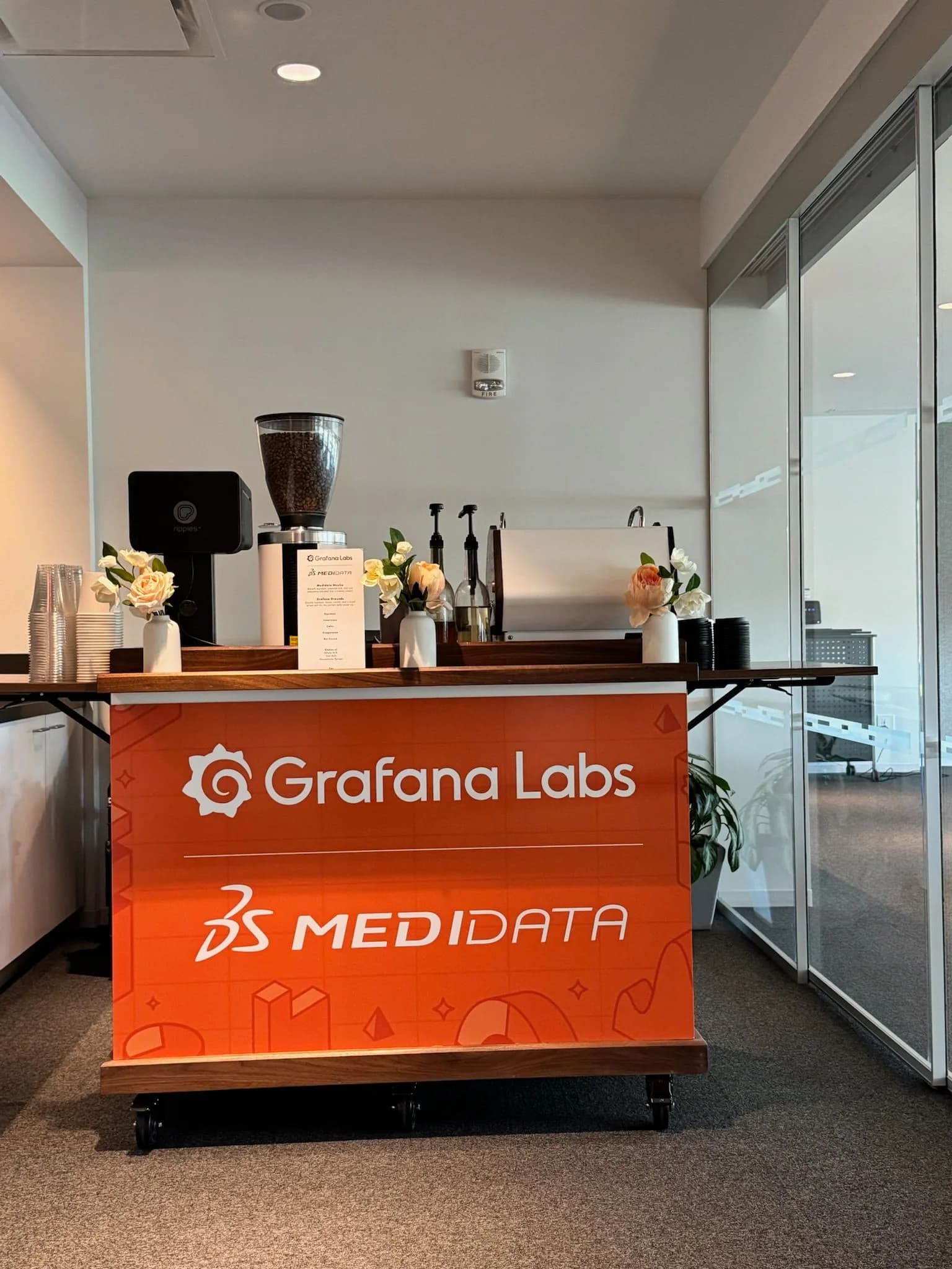 Co-branded Anechó coffee cart carrying two company logos at a client appreciation event in a New York office