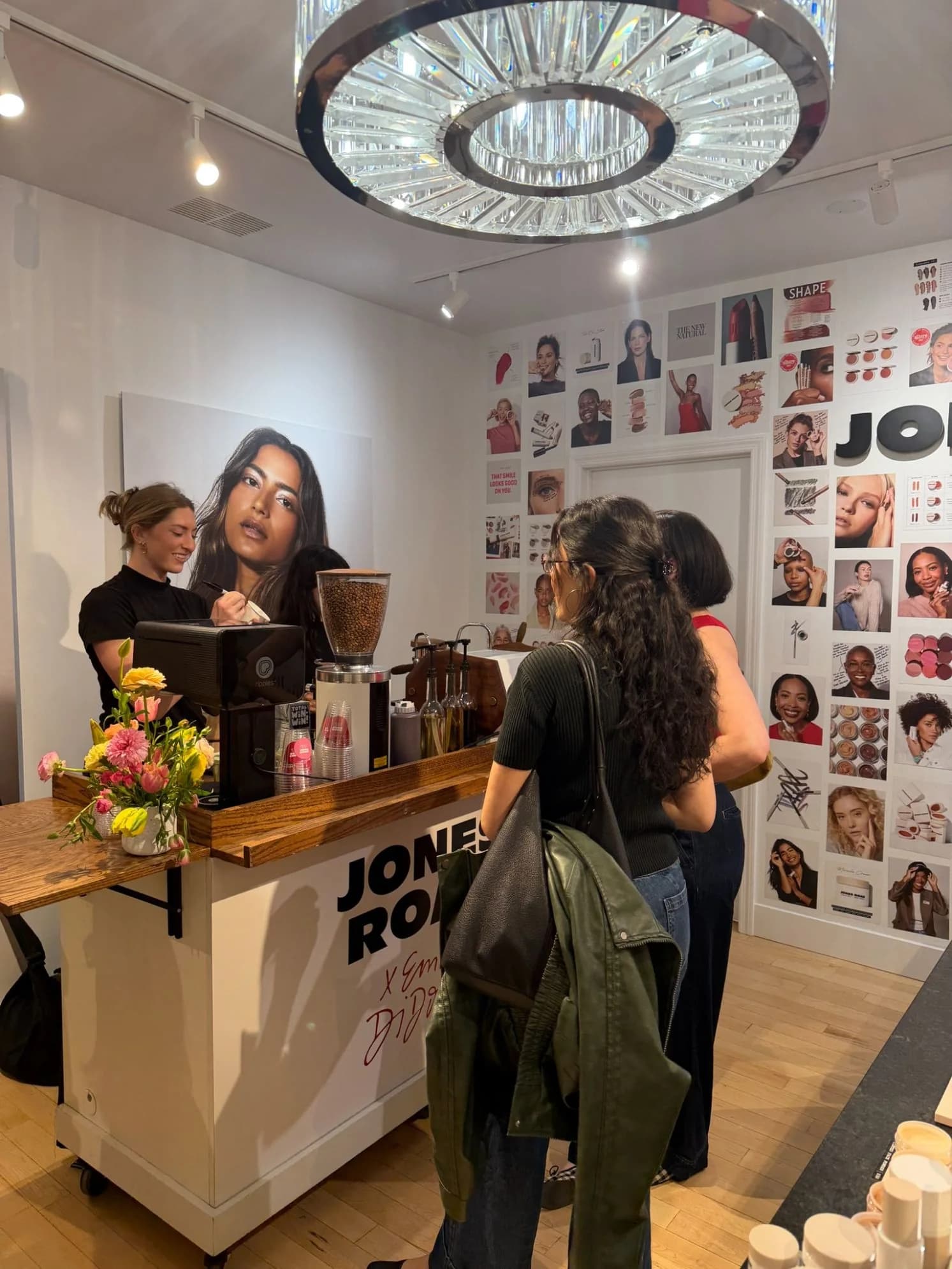 Guests waiting at a branded Anechó coffee cart inside a retail store during a product launch